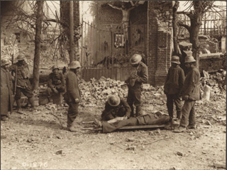 A Stretcher Bearer Dressing a Canadian Wounded at the Battle of Arleux, [ca. 1918]
