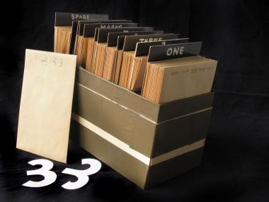 Box containing 97 envelopes, each holding several paper cut-outs used in an unfinished film.