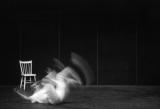 Claude Jutra rolls across the ground, having just missed a chair enjoying itself at his expense.