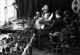 Norman McLaren works on the editing of the film A Chairy Tale using a Moviola editing machine.
