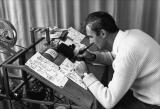 Norman McLaren demonstrates the drawing with pen and India ink directly on film stock.