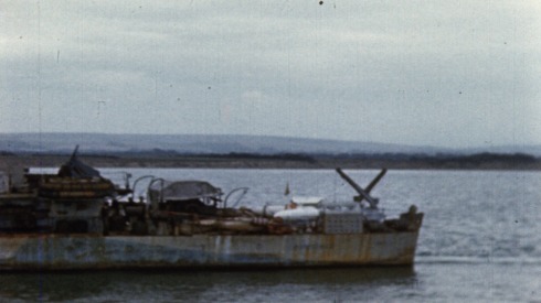 Colour footage : MCS of "HMCS Cowitchan" (Corvette J-146) passing camera. Men in lifeboat coming aboard HMCS Cowitchan (06/06/1944 or 07/06/1944).